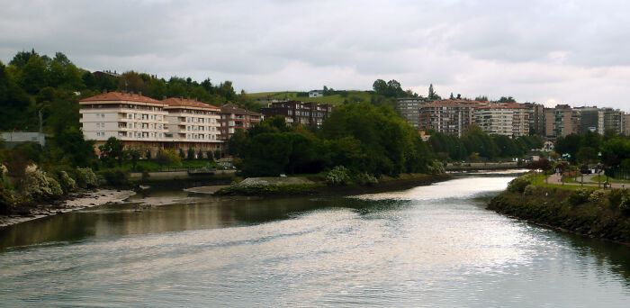 River view with buildings and green landscape illustrating geography facts