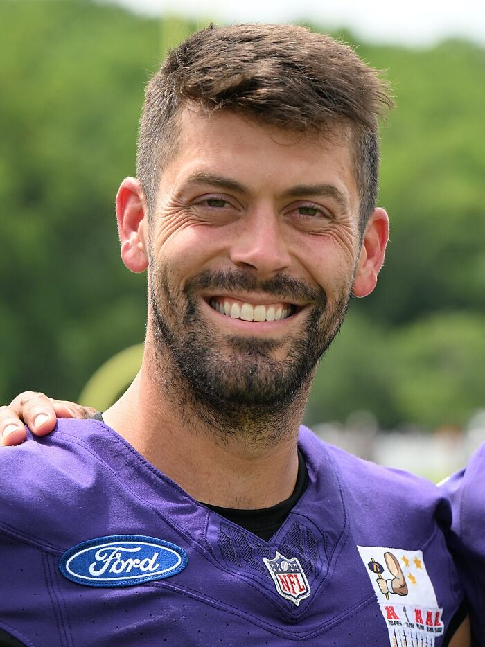 Smiling athlete in NFL uniform showing career downfall