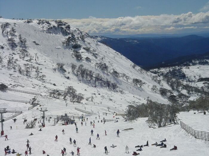 Skiers on snowy mountain slope with chair lifts stunning winter views