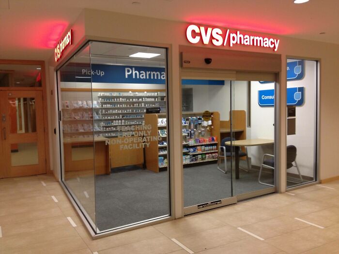 CVS pharmacy storefront inside building hallway with clear glass walls