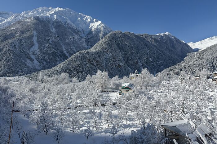Snowy mountain village under clear blue sky with spectacular stunning views of nature