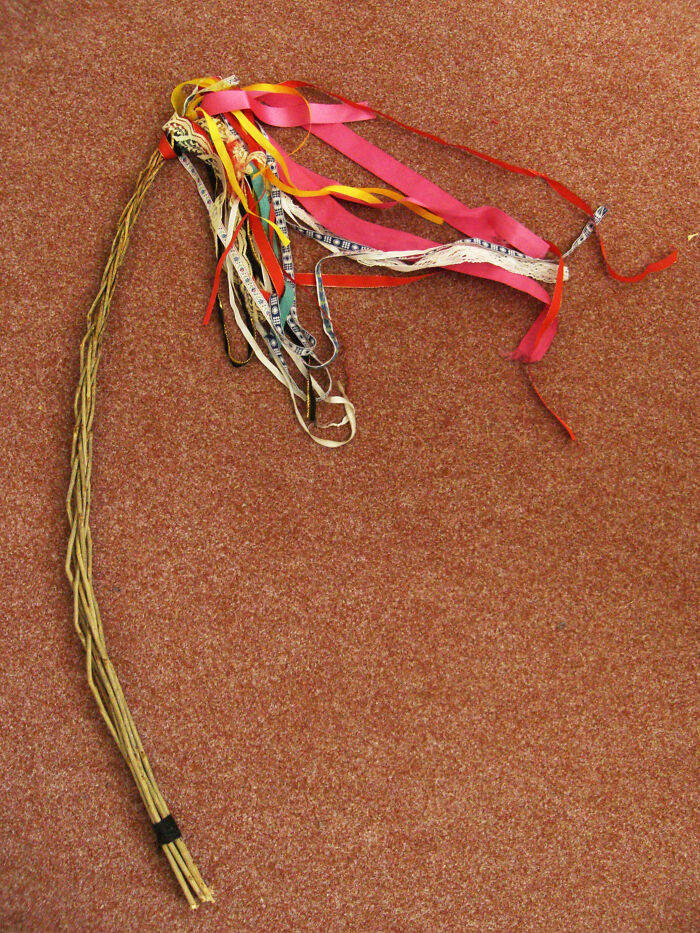 Whip decorated with colorful ribbons used in cultural celebration ritual