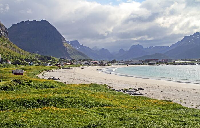 Coastal beach with mountains and lush green fields with stunning nature views