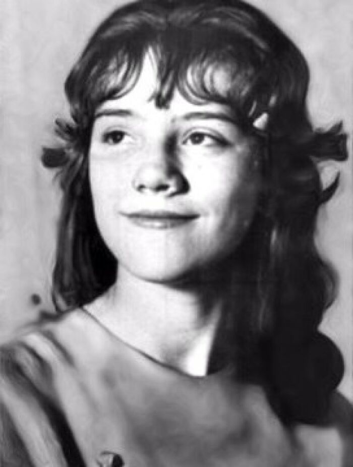 Black and white photo of a young woman with dark hair, a subtle smile, looking upwards. Disturbing d***h stories.