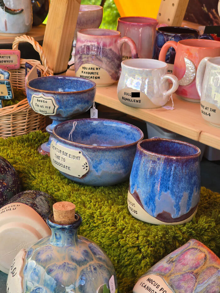 Colorful handmade ceramic pottery displayed with funny quotes
