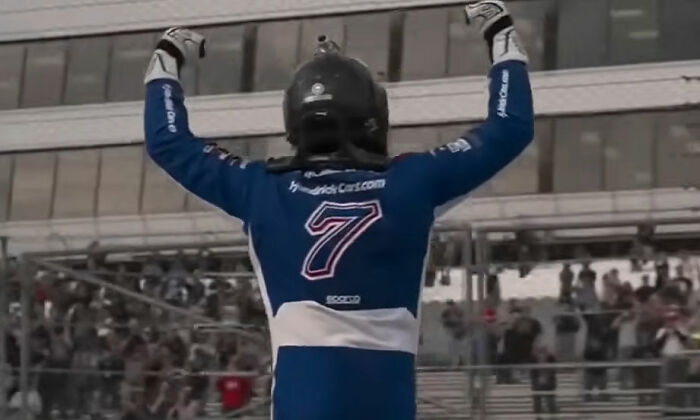 NASCAR star Kyle Busch celebrating victory on racetrack NASCAR star Kyle Busch celebrating victory on racetrack