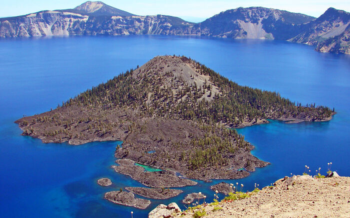 Volcanic island surrounded by clear blue lake stunning crater lake views