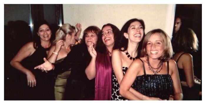 Group of women smiling with a shadowy figure in mirror unexplained bench photo