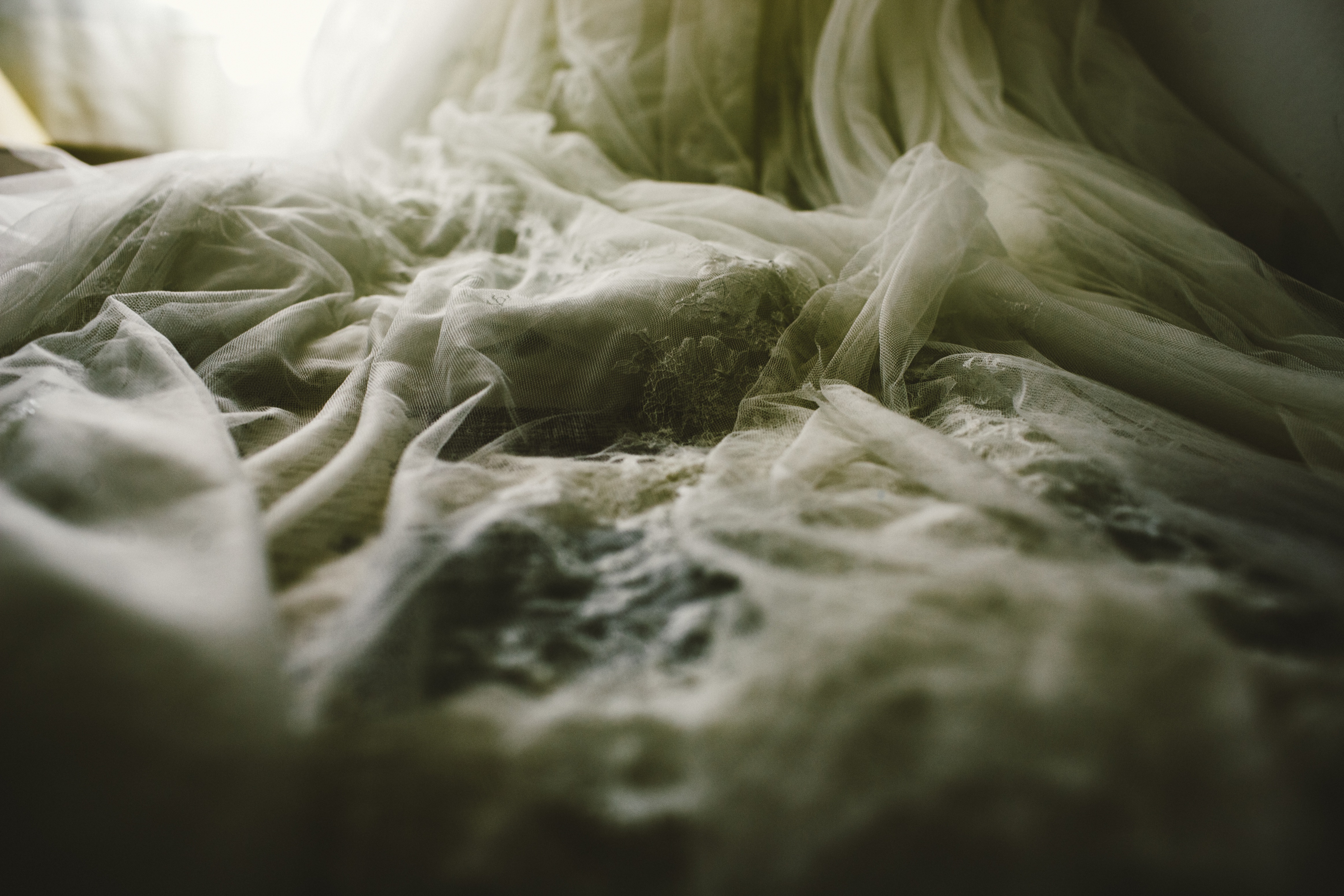 Close-up of wedding dress fabric with delicate lace and tulle detail