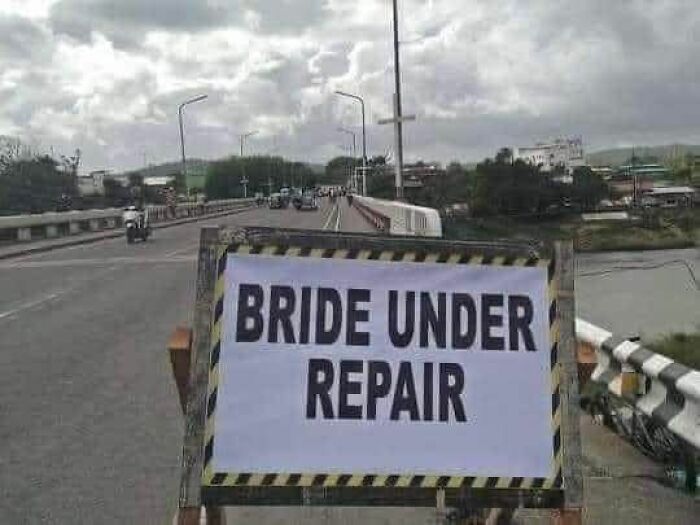 Humorous road sign saying bride under repair on highway