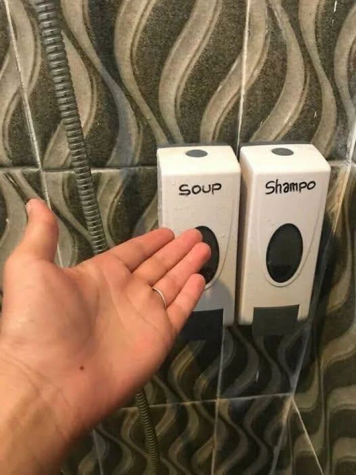 Absurd soap and shampoo dispensers mislabeled as soup and shampoo in bathroom