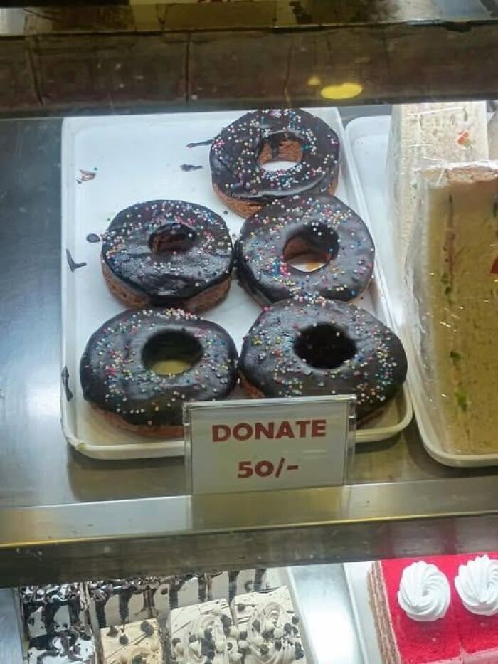 Donuts with sprinkles displayed alongside a donate sign