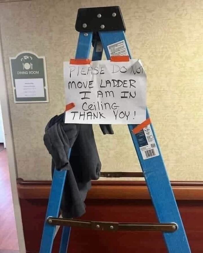 Unusual note on ladder says not to move because person is in ceiling