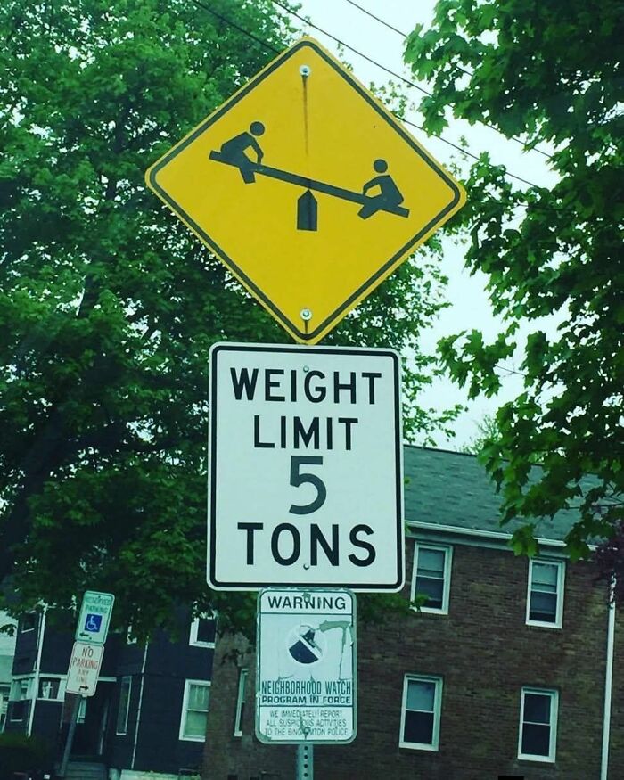 Humorous absurd sign showing weight limit 5 tons with seesaw illustration