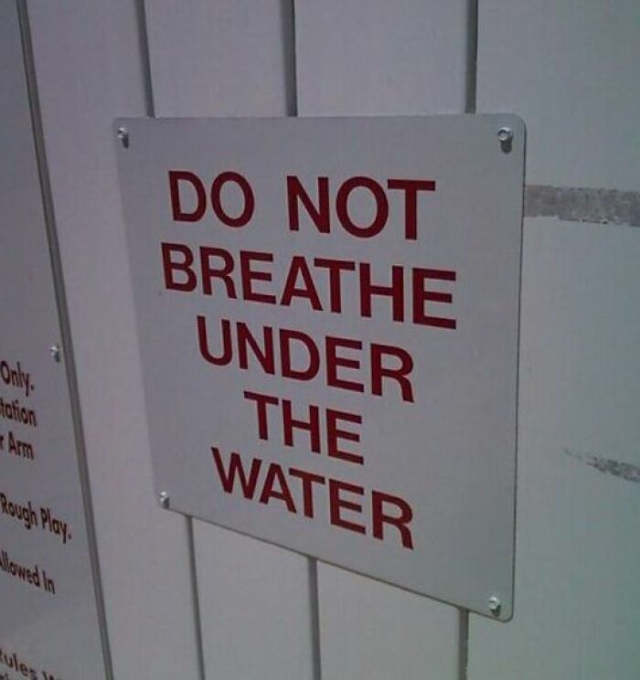 Funny absurd sign telling people to not breathe under the water