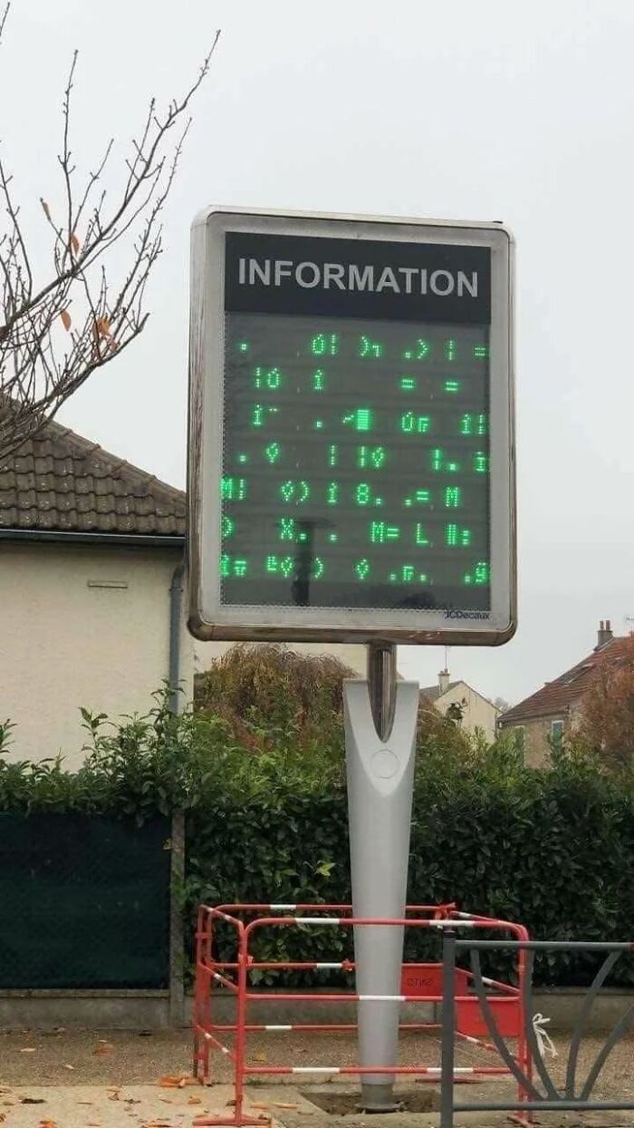 Outdoor digital information sign with unreadable glitchy text