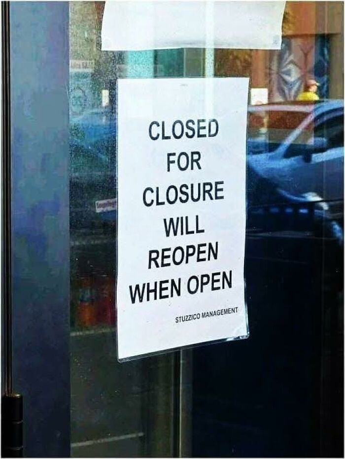 Sign stating closed for closure will reopen when open on glass door