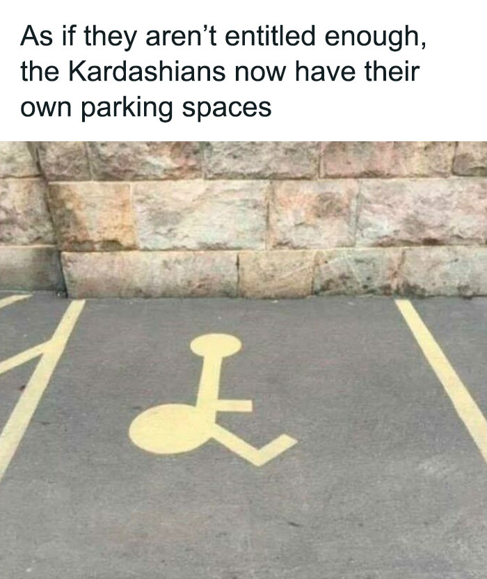Comical handicapped parking space marking altered to look like a Kardashian symbol