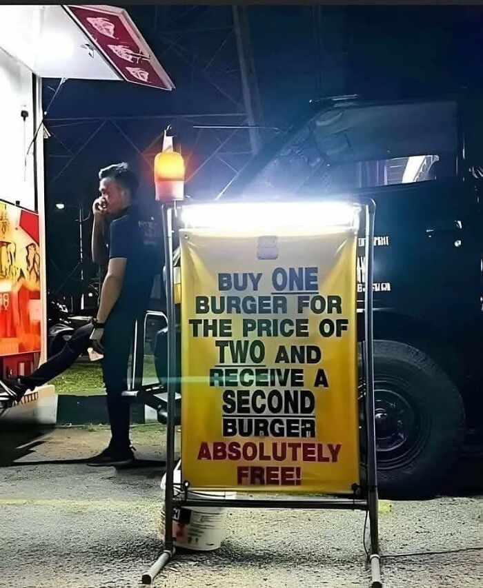 Sign saying buy one burger for price of two and get second burger free