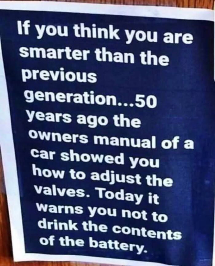 Sign criticizing modern car manuals compared to older ones about battery warnings