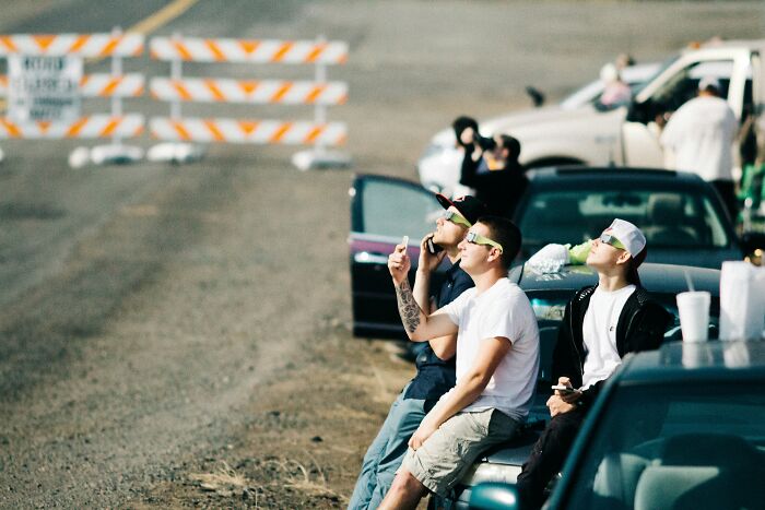 Group of people watching event from cars and roadside on January 6