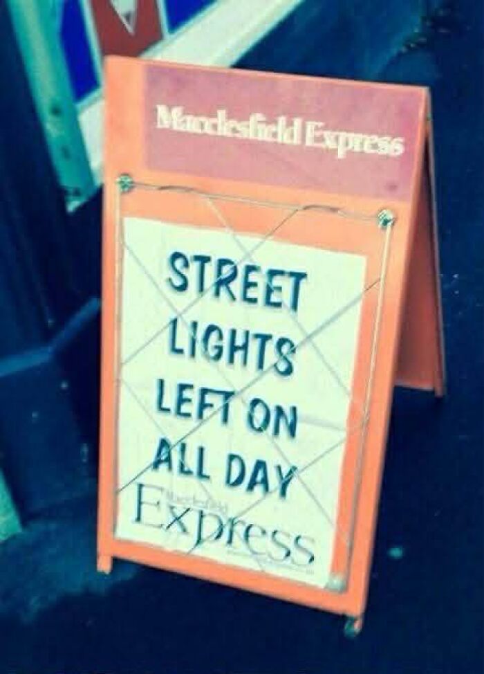 Humorous newspaper sign about street lights left on all day