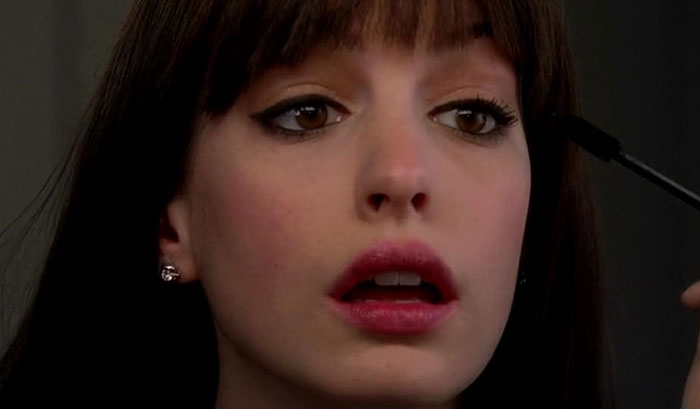 Anne Hathaway applying mascara in close-up beauty shot