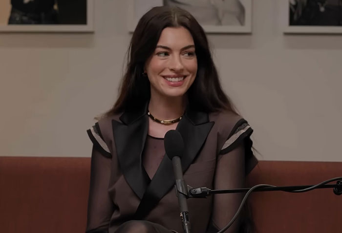 Anne Hathaway smiling during interview revealing health battle