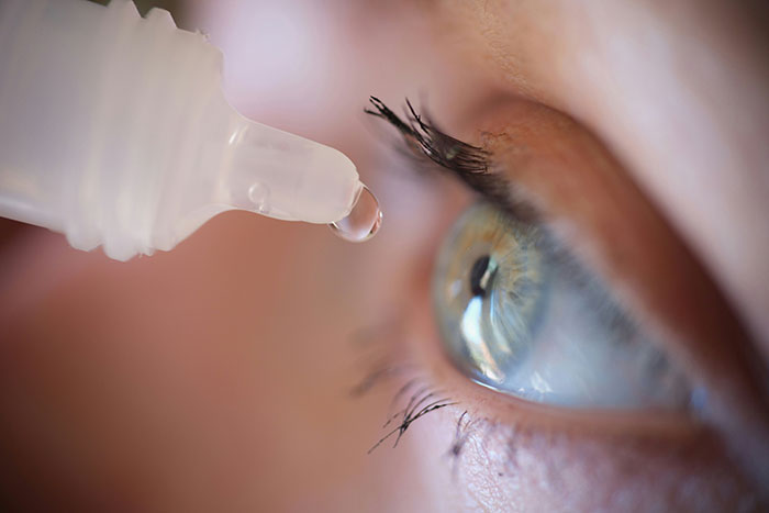 Close-up of eye receiving eye drops for health treatment