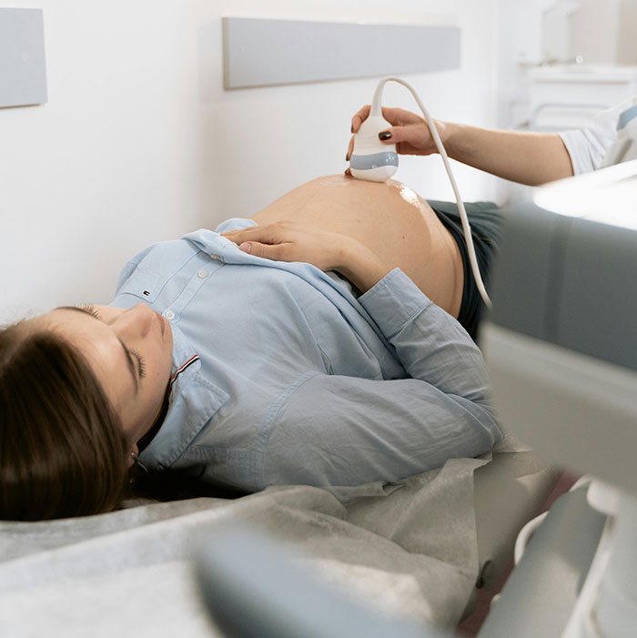 A pregnant woman having an ultrasound, symbolizing new beginnings and avoiding chaos, with a MILs theme.
