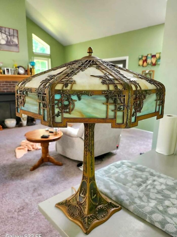 Art Nouveau style vintage secondhand lamp with stained glass shade in living room