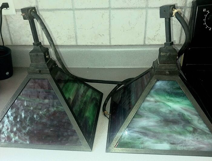 Pair of vintage stained glass pendant light fixtures with green triangular panels