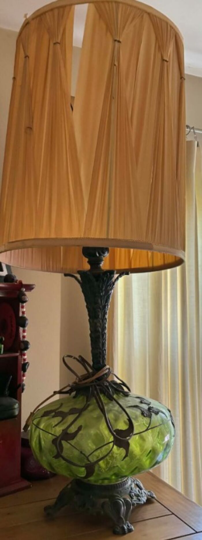 Large vintage lamp with green glass base and tall beige pleated shade