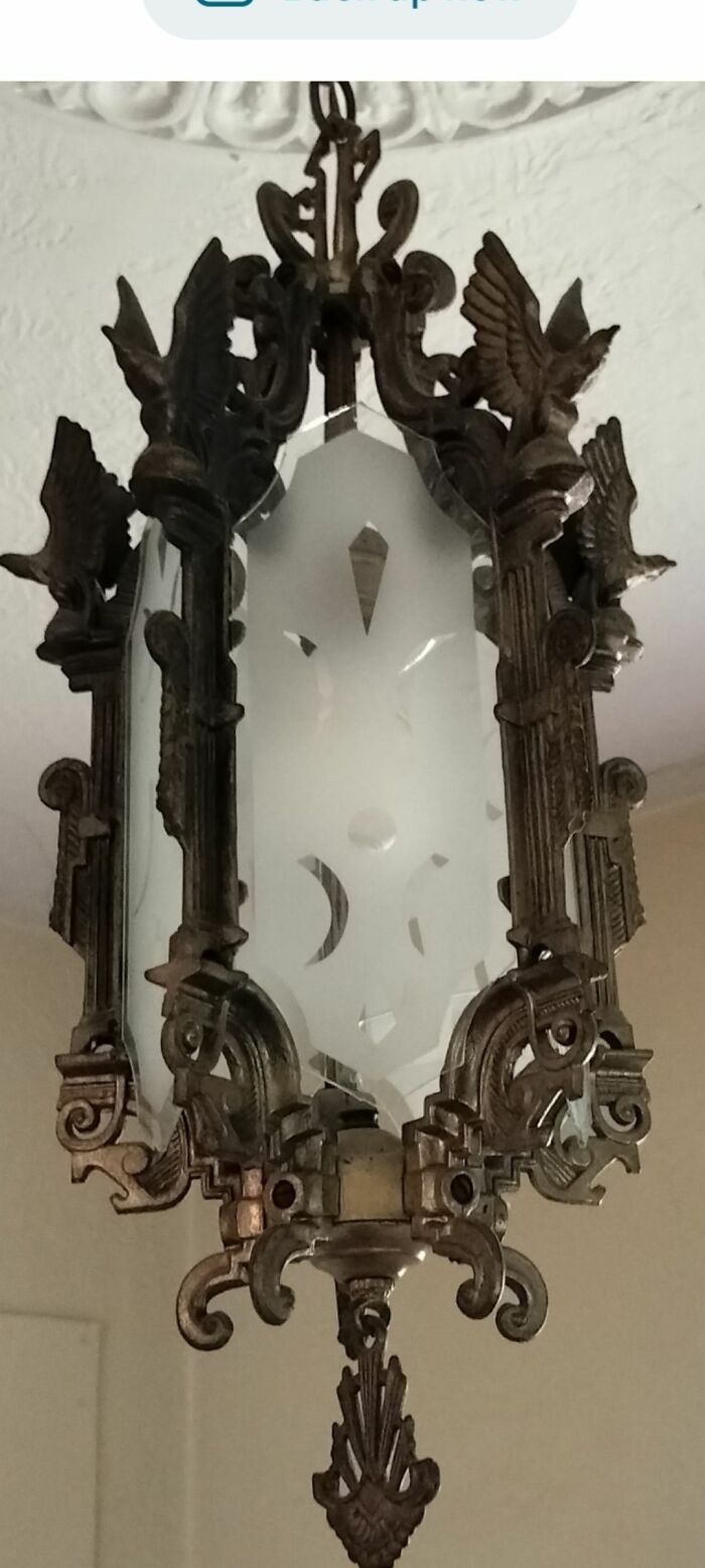 Intricate vintage secondhand metal and frosted glass hanging lamp with bird motifs