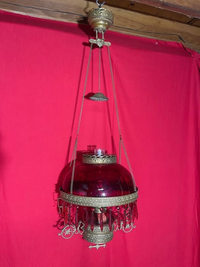 Antique vintage secondhand hanging oil lamp with red glass and brass details