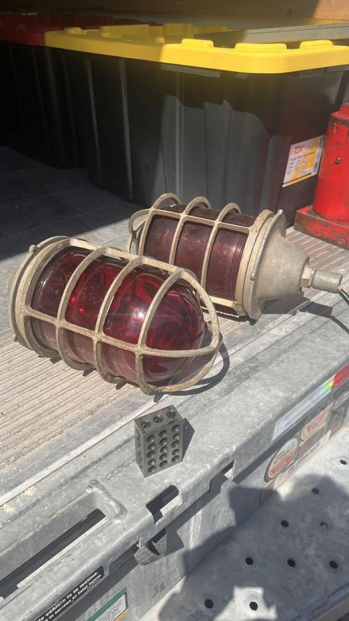 Retro vintage secondhand red glass aviation or industrial lamps with protective metal cages