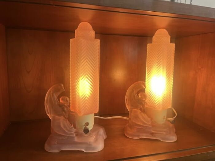 Pair of vintage secondhand art deco style glowing bedside lamps with figural designs