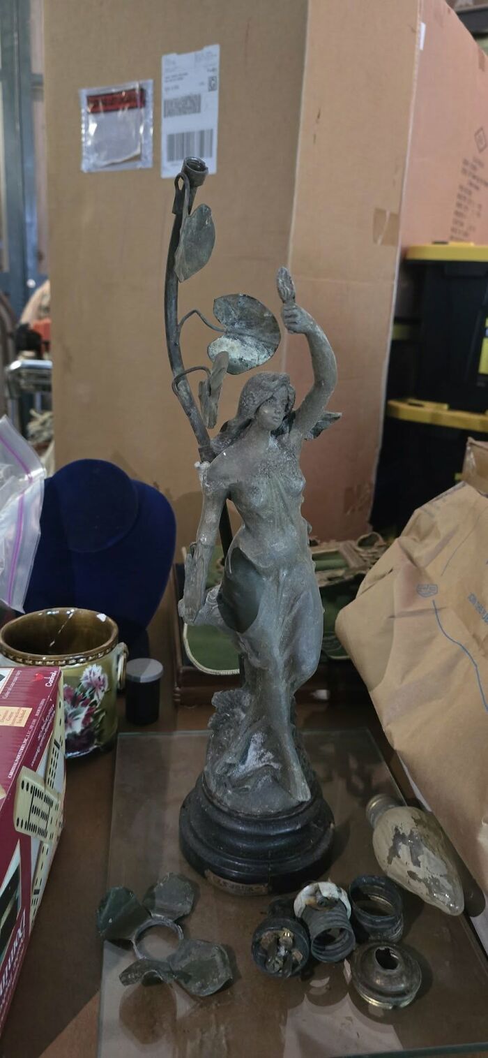 Vintage secondhand Art Nouveau style female statue lamp base with parts on table