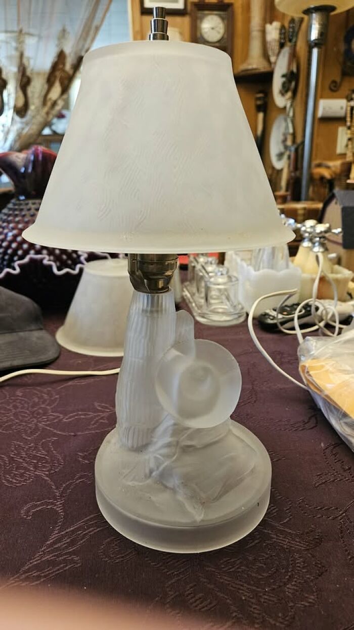 Vintage secondhand lamp with frosted glass shade and figurine base holding a horn