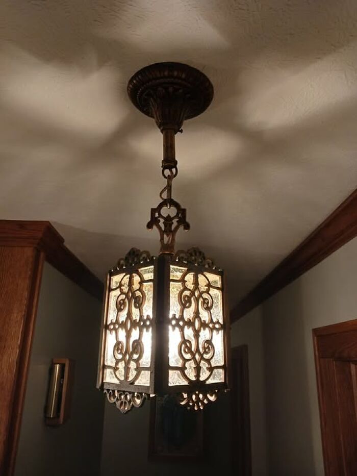 Vintage secondhand ceiling lamp with ornate metal frame and frosted glass panels
