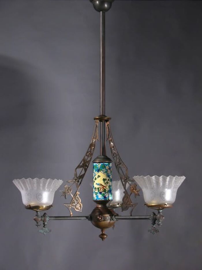 Antique vintage secondhand chandelier with floral glass shades and decorative metal frame