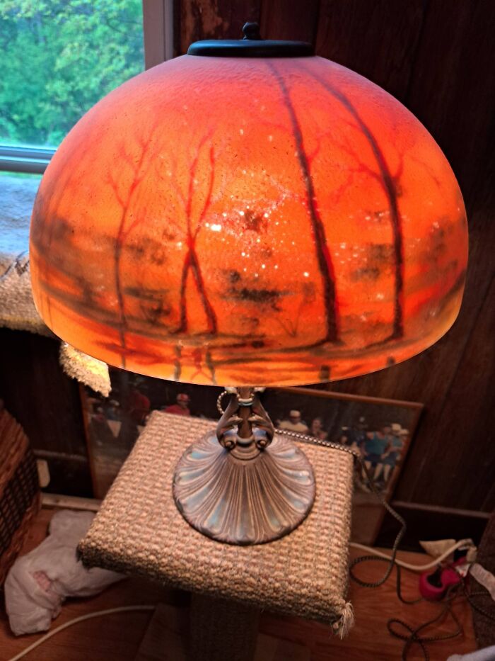 Vintage secondhand lamp with orange glass shade depicting a forest scene