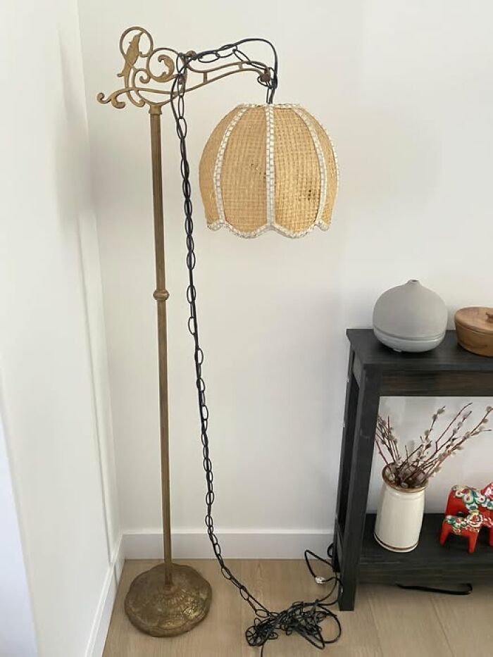 Vintage secondhand floor lamp with decorative brass stand and woven lampshade