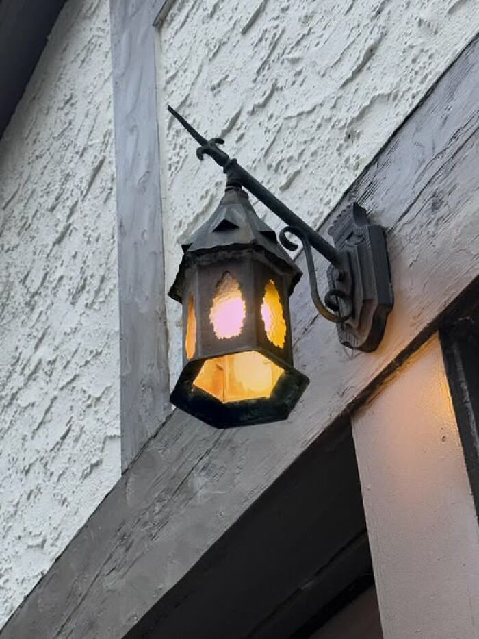 Outdoor vintage wall lantern with yellow lights and rustic metal frame