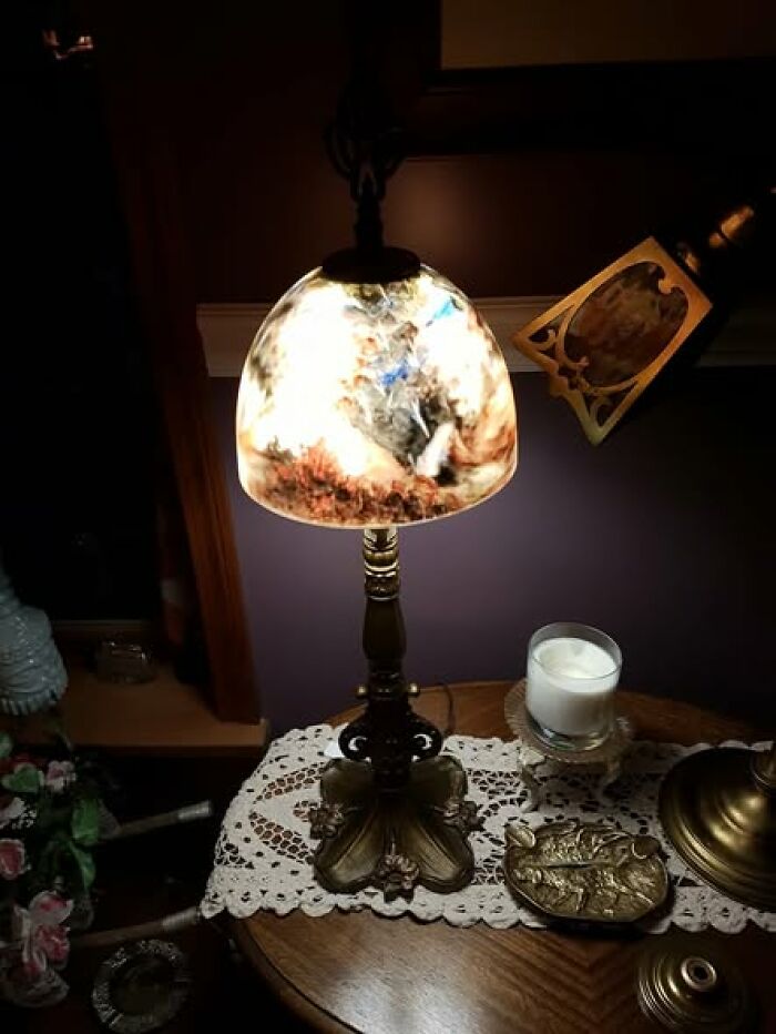 Antique vintage secondhand lamp with marbled glass shade on ornate metal base