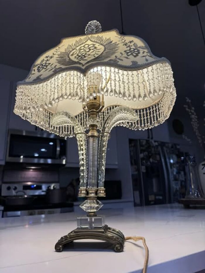 Elegant vintage secondhand lamp with beaded fabric shade and decorative glass base