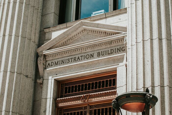 Stone entrance of the Administration Building, symbolizing industry secrets and job knowledge, and what employees didn't know.