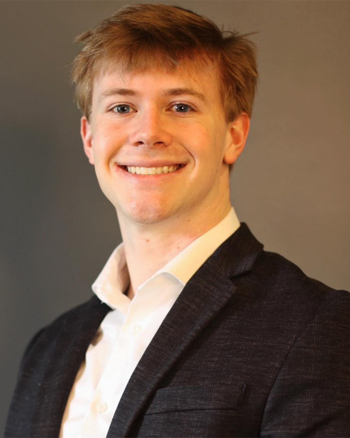 Young man smiling in suit portrait haunting autopsy