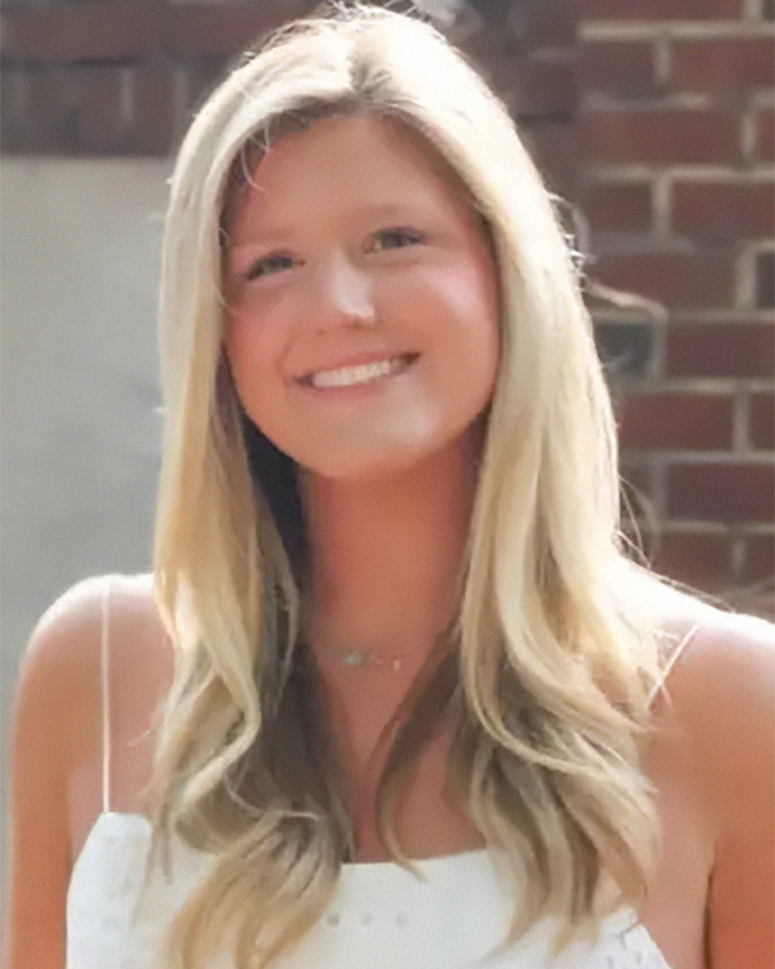 Smiling young woman in white dress portrait haunting autopsy