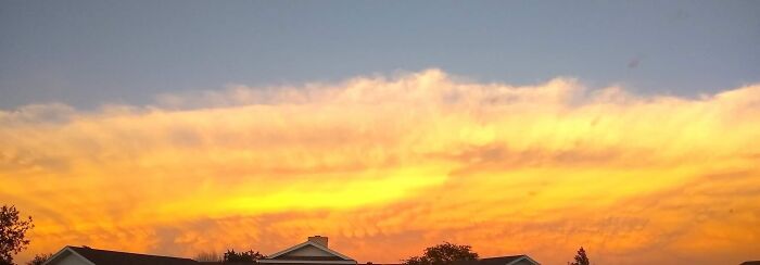 Colorful sunset sky over houses rare moments photo